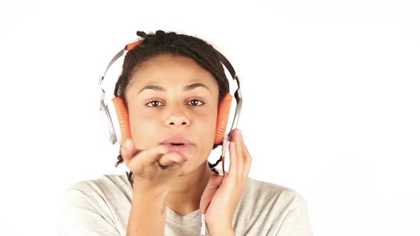 Young Woman Listening Music with Headphones and Flirting with Camera