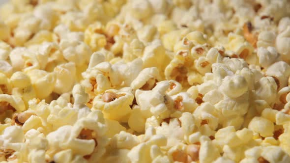  a Close-up of Newly Cooked Popcorn Rotating  in a Popcorn Dispenser