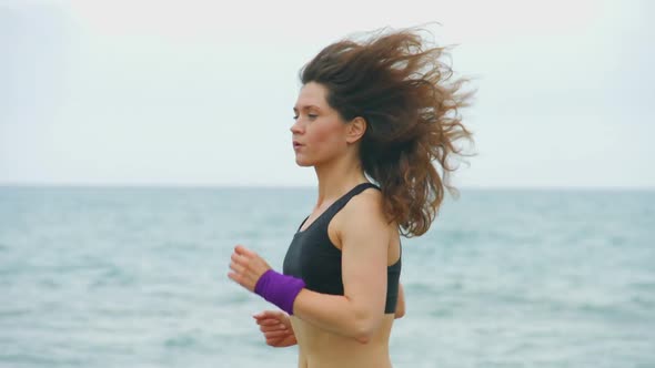 Beautiful Young Female Athlete Running Outdoors, Training for Sports Competition