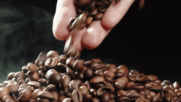 Hand Touching Roasted Coffee Beans