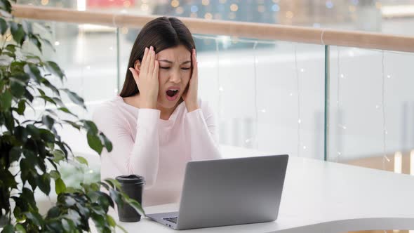 Confused Asian Woman Worker User Reading Bad Email on Laptop Feeling Depressed Shock Stress of