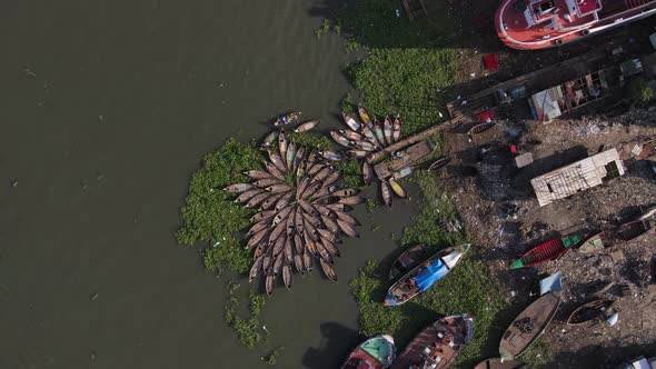 Aerial ascending view over unauthorized and illegal shipyard causing environmental degradation. Bang