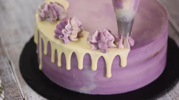 Chef Decorating Cake with a cream.	