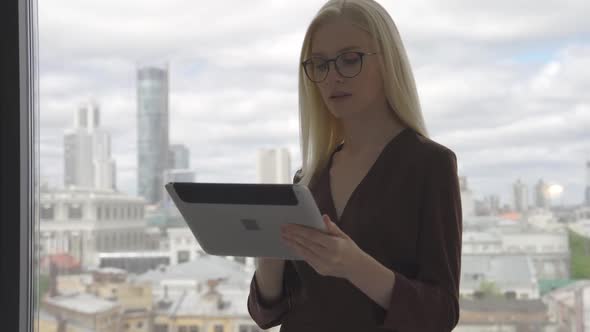 Female Manager Using Digital Computer Tablet in Office