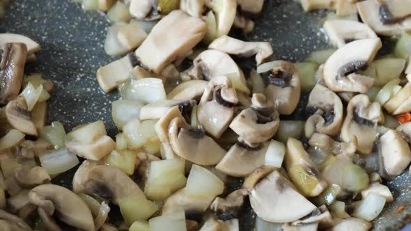 Closeup of Cooking Fried Mushrooms in a Frying Pan