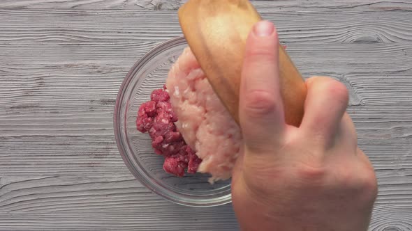 Top View of the Male Hands Mixing the Various Kinds of Raw Minced Meat in a Bowl