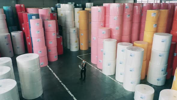Female Specialist Observing Large Paper Warehouse