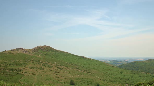 Timelapse of wispy clouds over picturesque green hill, STATIC CROP