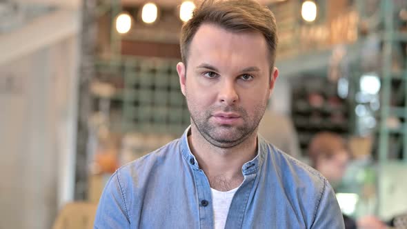 Portrait of Attractive Casual Man Looking at Camera