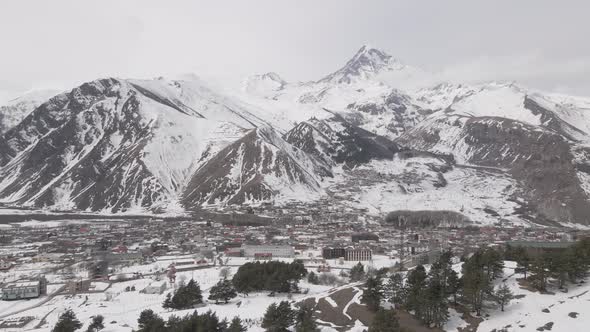 Aerial view of beautiful snowy mountains in Stepantsminda, Georgia