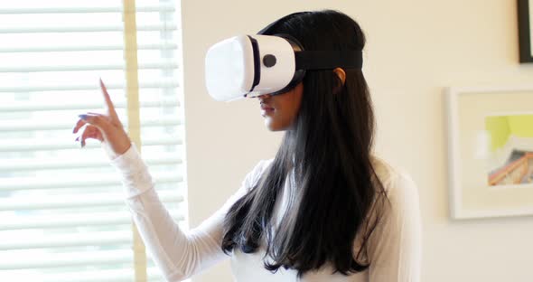 Woman using virtual reality headset in living room