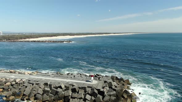 Drone shot - flying away with a great view of the Gold Coast Seaway and South Stradbroke Island, Que