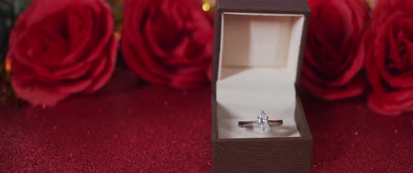 Diamond ring in a box and silk Red roses