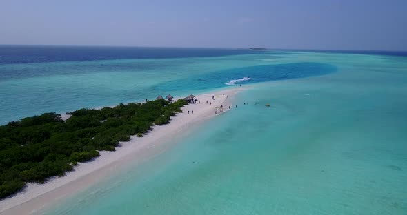 Wide angle aerial abstract shot of a white sandy paradise beach and blue ocean background in 4K