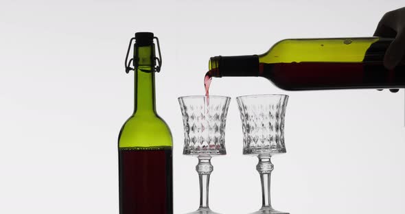 Rose Wine. Red Wine Pour in Two Wine Glasses Over White Background