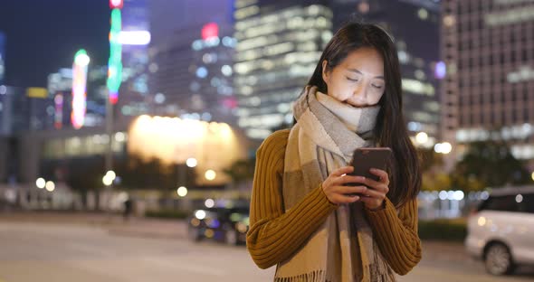 Asian woman use of smart phone at night