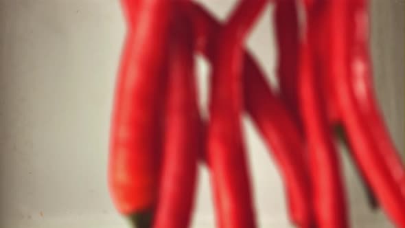 Super Slow Motion Red Hot Chili Pepper Falls Into the Water with Splashes