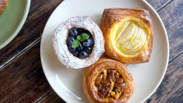 Top View of Pastry on Plates with Teapot and Cup of Coffee Morning Sweet Food