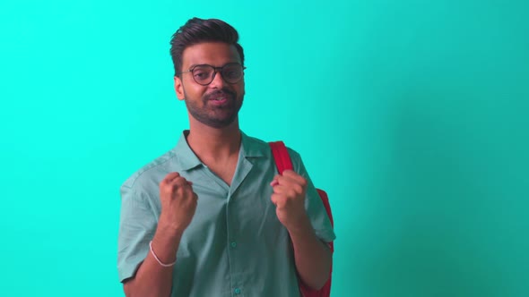 Indian Student Man Feeling Inspiration Idea Wear Eye Glasses Holding a Pencil in Blue Studi