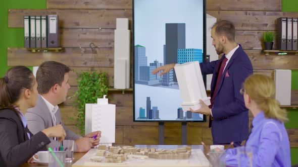 Architect in Business Suit Holding a Presentation