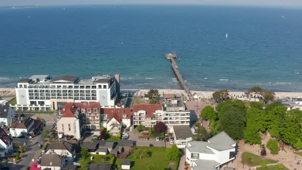 Aerial View Flying Above Buildings Facing Baltic Sea Beach Coastline on Summertime Sunny Day