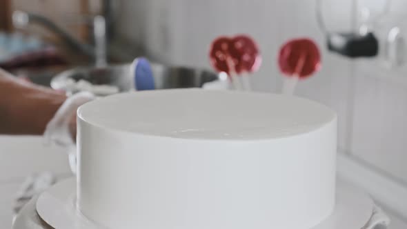 Woman Chef Making a Cake  Showing a Cake Covered with White Cream