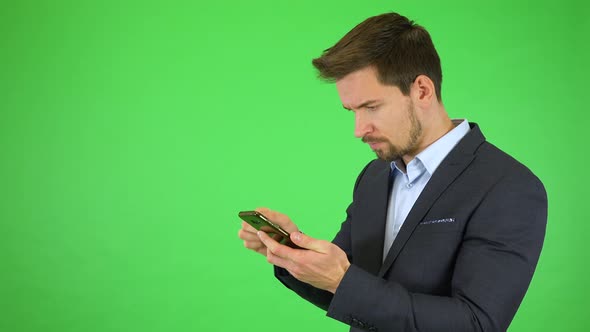 A Young Businessman Tries To Make a Broken Smartphone Work, Gets Angry - Green Screen Studio