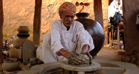 Indian Potter at Work: Throwing the Potter's Wheel and Shaping Ceramic Vessel and Clay Ware: Pot