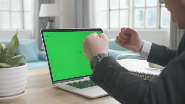 Successful Asian Businessman With Green Screen Computer While Working At Home