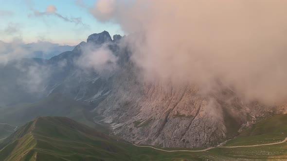 Sunrise in the Dolomites mountains with fog and mist