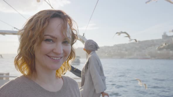 Beautiful woman smiles on boat in sunny weather