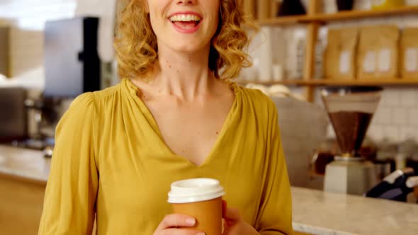 Portrait of beautiful woman offering coffee 4k