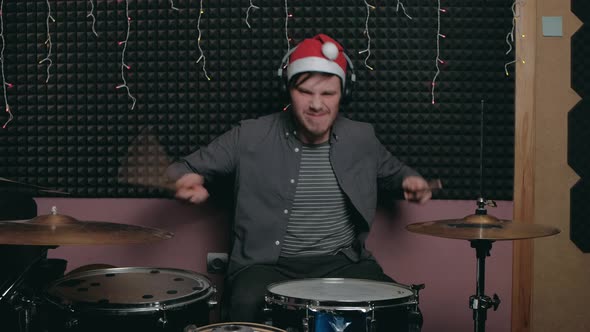 Funny Santa Claus Man Sits Down to Play the Drum Set