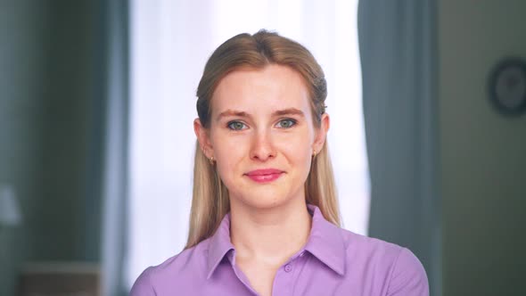 Smiling young woman in apartment, slow motion