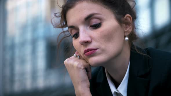 Thoughtful and day dreaming business woman close up portrait