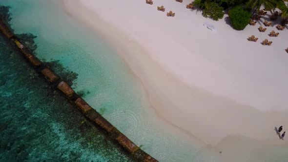 Aerial drone abstract of bay beach break by blue water with sand background