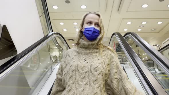 Woman Customer in Mask on Escalator in Shopping Mall