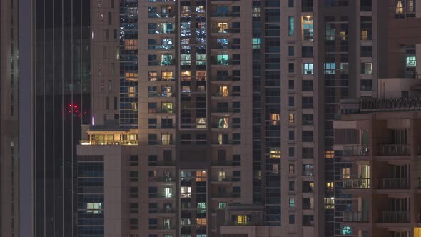 Windows in Highrise Building Exterior in the Late Evening with Interior Lights on Timelapse