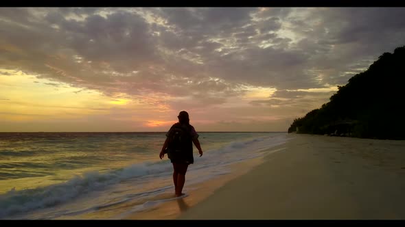 Tourist suntans on beautiful tourist beach break by blue green water with white sandy background of 