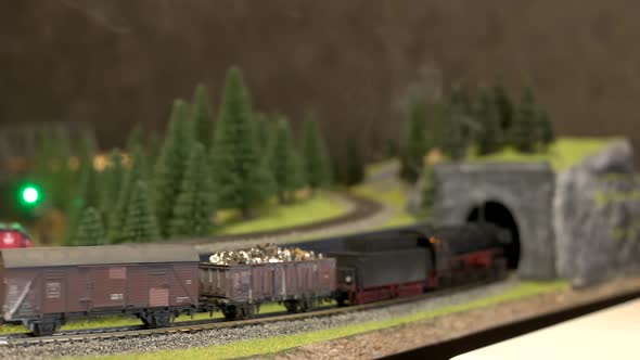 Toy Train with Smoke Moving on Model Railway.