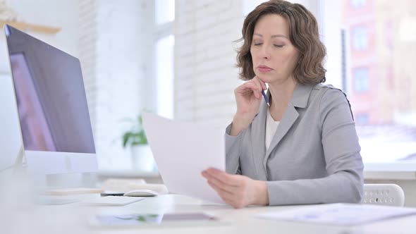 Creative Old Woman Working on Document