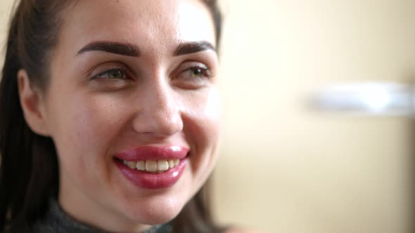 Closeup Portrait of Satisfied Smiling Young Woman with Toothy Smile and Toothbrush Looking Away in