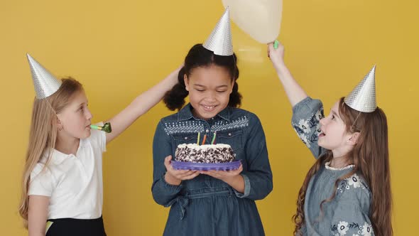 Kids with Birthday Cake Celebrating Birthday Copy Space Orange Background