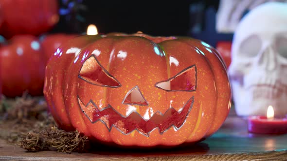 Close Up Scarry Dolly Shot of Carved Pumpkin on a Table