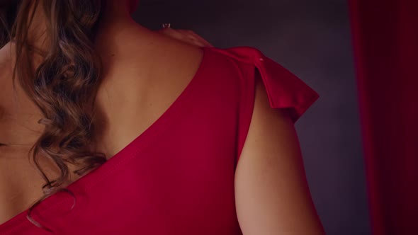Closeup a Woman Straightens a Red Dress Standing in a Hotel Room a Woman is Preparing for the
