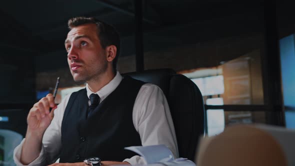 Male Architect Working Thinking in the Office on a Residential Building Project