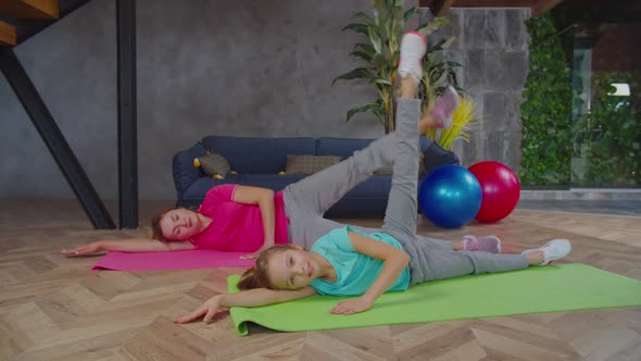 Sporty Fitness Mother and Kid Doing Side Leg Lift