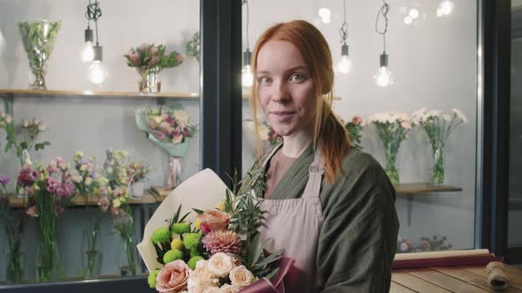 Portrait Of Pretty Florist With Bouquet Of Flowers