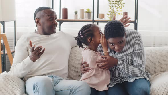 Afro American Family Sitting on Home Sofa Together Black Mixed Race Ethnic Little Girl Daughter