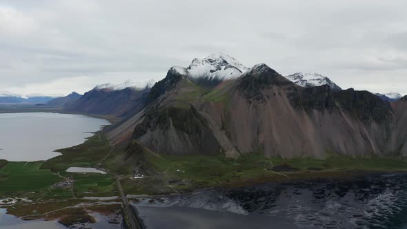 Drone Panning Over Black Sand Beach And Vestrahorn Mountain